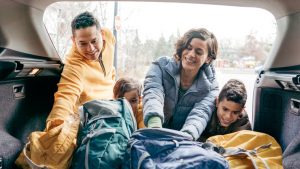 Family loading a car trunk before the road trip